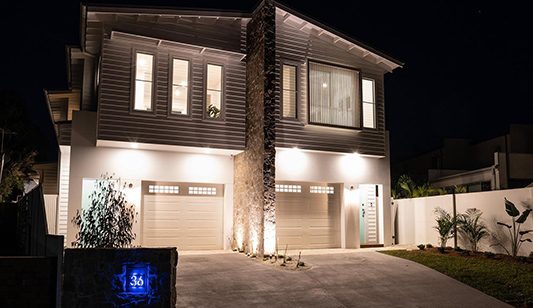 A residential home at night with beautiful lighting freshly installed