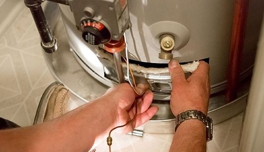 An electric hot water system being repaired