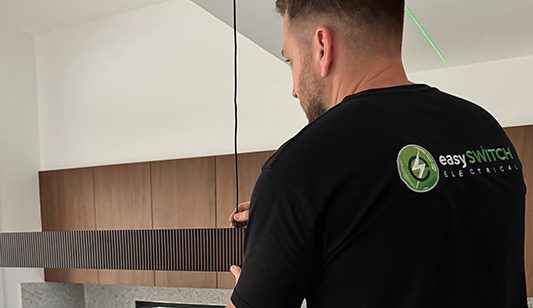 An Easy Switch Electrical electrician rewiring a lighting fixture