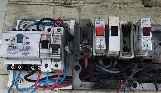 An old electrical switchboard burnt out from old wiring