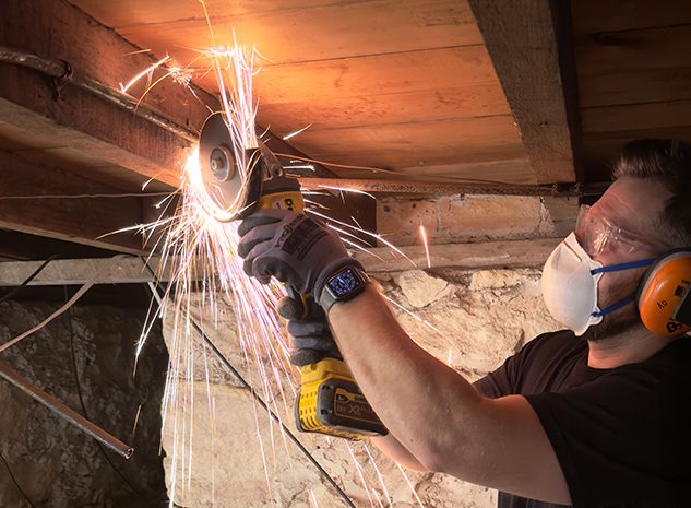 An electrician removing old electrical wiring from a home